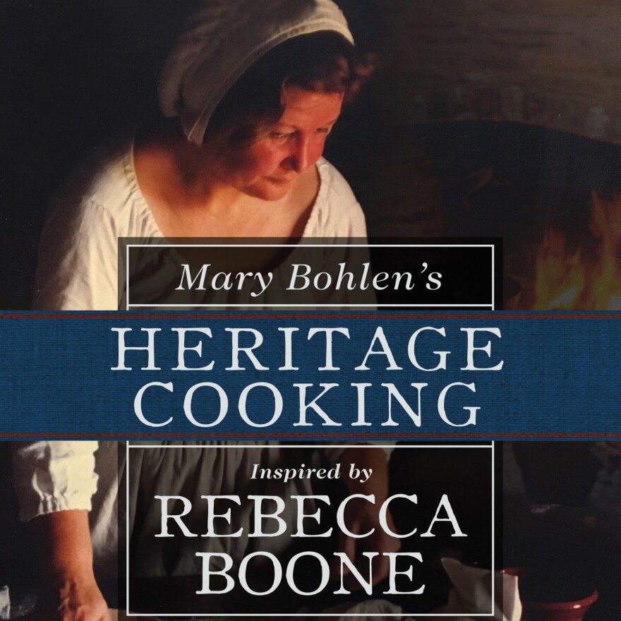 Cover of "Mary Bohlen's Heritage Cooking Inspired by Rebecca Boone" featuring an 18th century woman preparing a meal