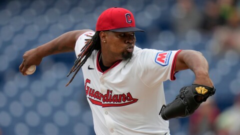 Luis Ortiz is shown mid-pitch while wearing a Cleveland Guardians white home uniform.