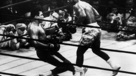 Muhammad Ali (right) goes down in the 15th round of a title fight in 1971 to a left hook from world heavyweight champion Joe Frazier. 