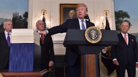 President Trump speaks about the recently passed spending bill at the White House on Friday. Trump threatened to veto the bill before later signing it. CREDIT: NICHOLAS KAMM/AFP
