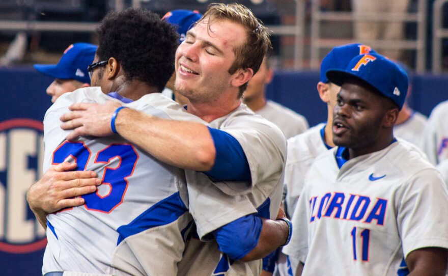 Peter Alonso celebrates with teammate Buddy Reed after defeating FSU 11-4 in the Gainesville Super Regional on June 6.