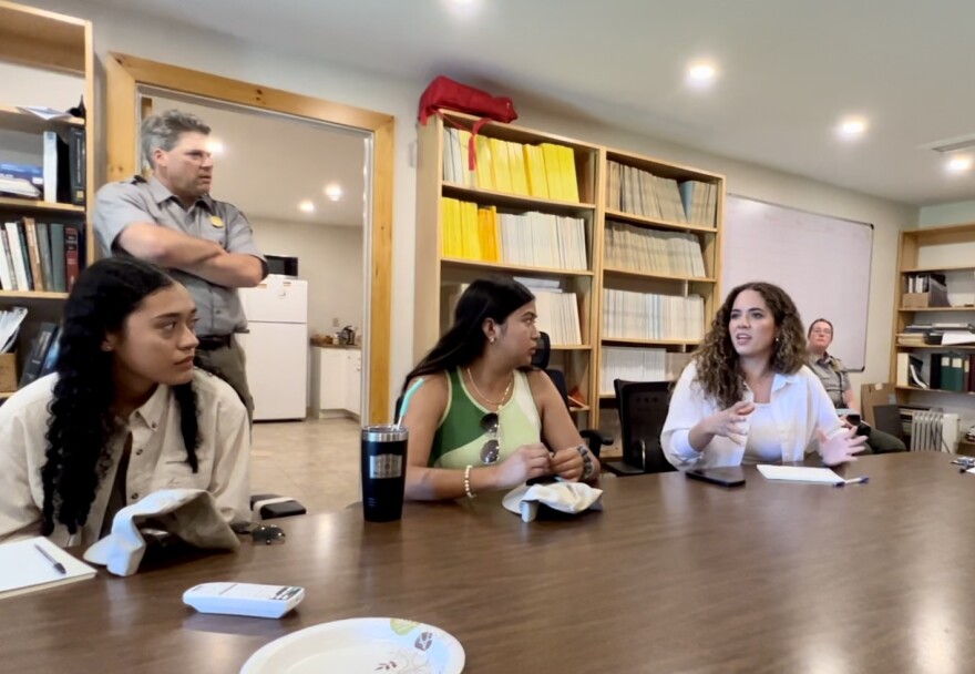 College student Alejandra Garcia, visiting from Mexico, talks with Cape Cod National Seashore staff about the environmental problems facing Lake Pátzcuaro. Seated with her at the table are students Valeria Aguilar, left, and Ireri Servín.