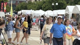 Residents walk through the 2025 Ann Arbor Art Fair.