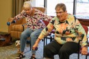 Older adults including Mady Montague, right, lift dumbbells during an “Injury and Fall Prevention” class offered by Merced College at an assisted living home in the city.