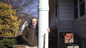 Jack Romine stands near a makeshift chimney state inspectors installed over an abandoned, leaky well that was discovered near his home in Bartlesville, Okla.