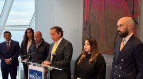 Tony Buzbee speaks at a press conference in Houston flanked by Brianna Aguilera's mother, right, and father, left. Dec. 5, 2025. 