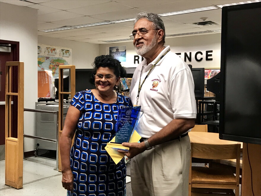 Boodnaraine Tihal, right, poses with his wife after the Broward Teacher's Union honored him with a plaque at Seminole Middle School Tuesday.