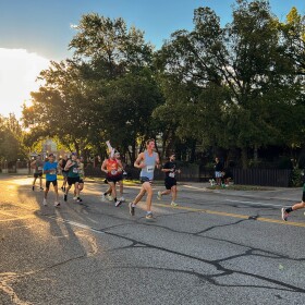 A group of marathoners and half-marathoners runs alongside a pacer — a runner running a predetermined pace — west on Douglas. The 2025 Prairie Fire Marathon route took runners through College Hill and back again.