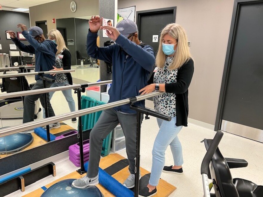 P.G. Peeples,Sr. and Physical Therapist Melissa Wilson at Baptist Health in Jessamine County