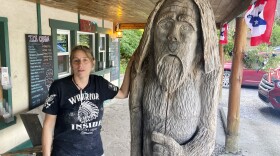 Pauline Bauer leans against a wooden statue outside Bob's Trading Post, her restaurant in Hamilton, Pa., July 21, 2021. A federal judge has convicted a Bauer of storming the U.S. Capitol, where she screamed at police officers to bring out then-House Speaker Nancy Pelosi so the pro-Trump mob could hang her.