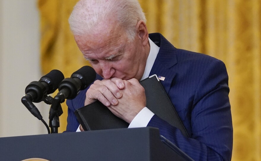 President Biden pauses, as he listens to a question about the bombings at the Kabul airport that killed 13 U.S. service members.