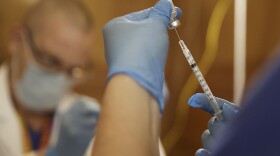 Charles Mandelin and Katie Overbey prepare the first Pfizer COVID-19 vaccines for administering at Duke University Hospital in Durham on Monday, December 14, 2020. 