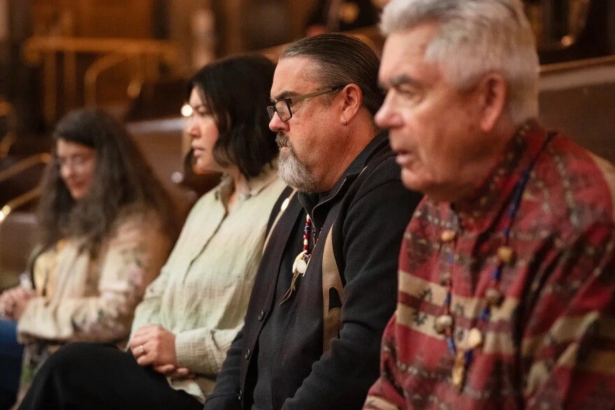 Four people sitting in a row.