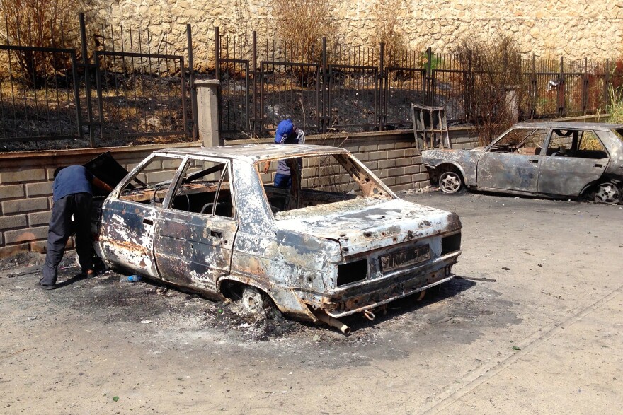 Boys search destroyed cars for salvageable parts in Silvan, a town facing repeated clashes between Turkish forces and militant Kurdish youth.