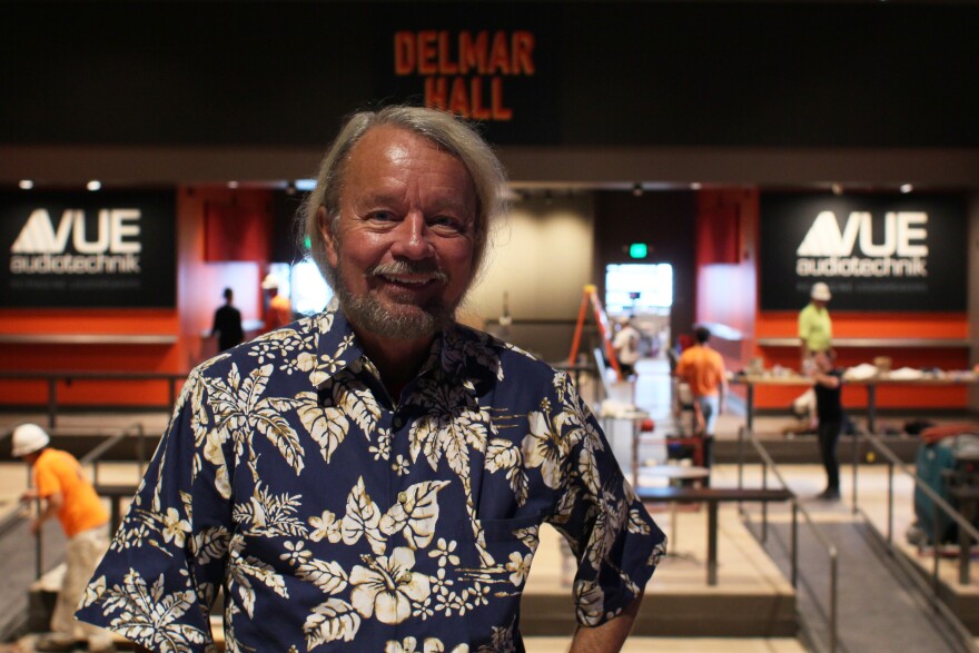 Joe Edwards, in Hawaiian shirt stands on the Delmar Hall Stage one day before the venue's grand opening.