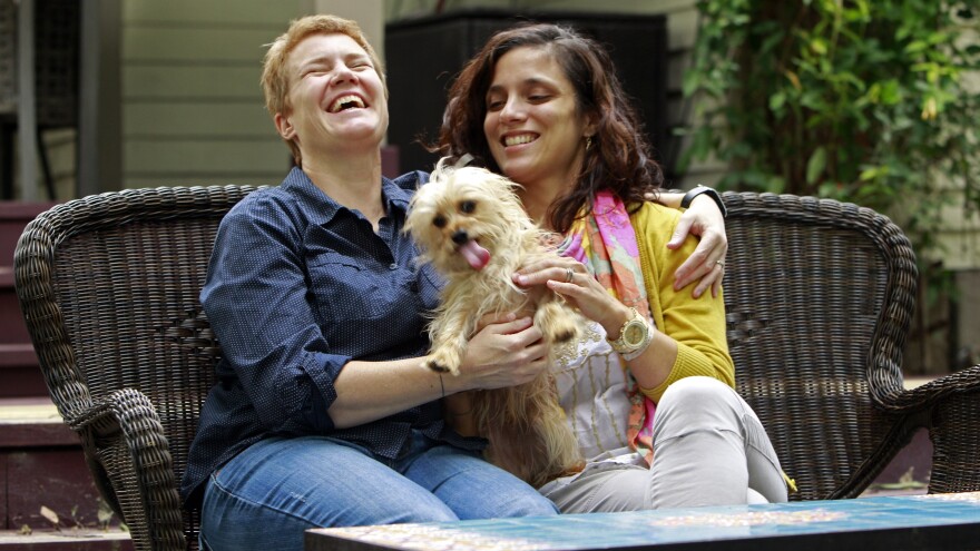 Veterinarians Sophy Jesty (left) and Val Tanco with their dog, Biscuit, at home in Knoxville, Tenn.