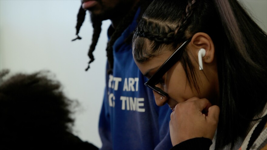 AS220 Youth member Janirah working with youth mentor Jay Lew on a verse