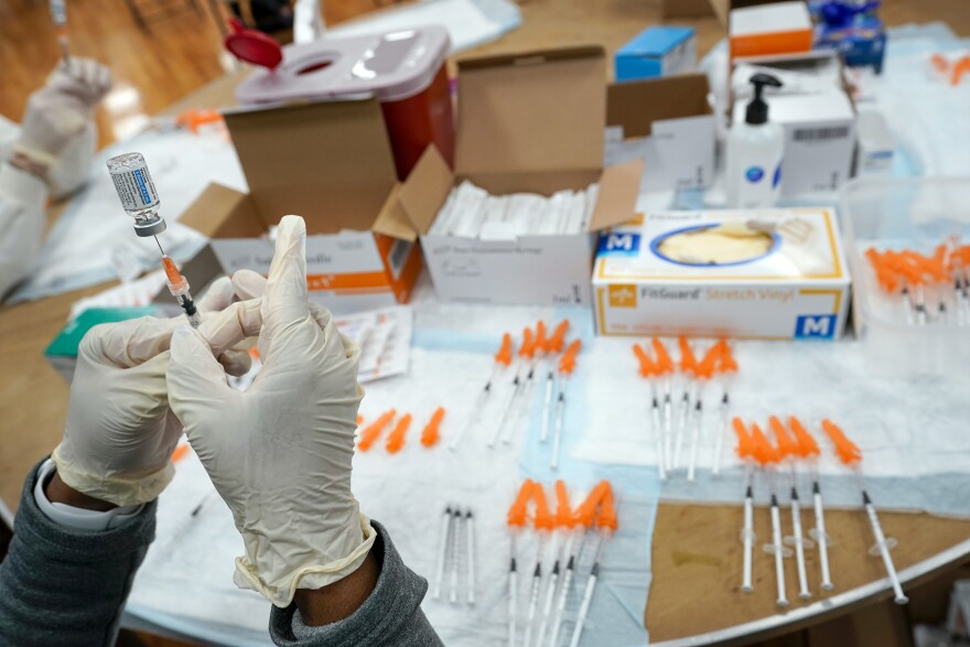 A Northwell Health registered nurse fills a syringe with a COVID-19 vaccine at a pop up vaccination site the Albanian Islamic Cultural Center, April 8, 2021, in the Staten Island borough of New York. (AP Photo/Mary Altaffer, file)