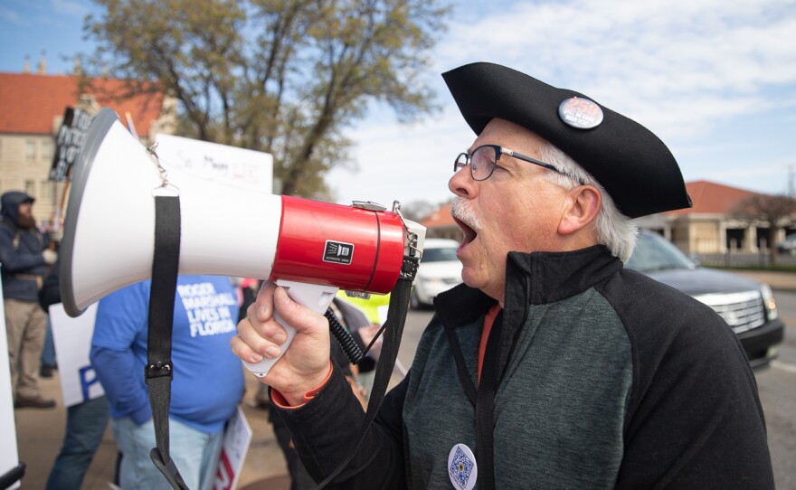 A demonstrators chants into a megaphone while preparing for the No Kings protest in Wichita, Kan. on Saturday, March 28, 2026.