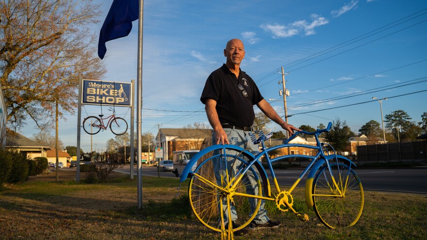 James Moore stands beneath a purple flag he raises every time someone in Hattiesburg dies from an opioid overdose outside his bike shop in Hattiesburg, Mississippi, on Thursday, January 29, 2026. Moore was on the council that reviewed applications for funding and submitted recommendations to the state’s legislature.