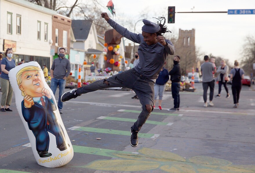 <strong>MINNEAPOLIS:</strong> Ira Culp of Minneapolis kicks a Donald Trump punching bag on Saturday, near the intersection where George Floyd was killed by police in Minneapolis.