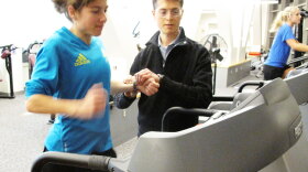 Ben Rapoport takes Erin Wyner's pulse as she runs on a treadmill to determine how many carbohydrates she should eat to run a successful marathon.