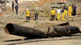 In this Sept. 11, 2010, file photo, a natural gas line lies broken on a San Bruno, Calif., road after a massive explosion. A federal jury found Pacific Gas & Electric Co., California's largest utility, guilty on Tuesday, Aug. 9, 2016, of misleading investigators about how it was identifying high-risk pipelines after the deadly gas line explosion in the San Francisco Bay Area. (AP Photo/Noah Berger, File)