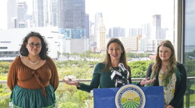 Florida Commissioner of Agriculture and Consumer Services Nikki Fried, center, speaks during a news conference along with youth climate leaders, Valholly Frank, left, and Delaney Reynolds, right, Thursday, April 21, 2022, at the Phillip & Patricia Frost Museum of Science in Miami. Fried unveil a proposed rule to require that utilities operating in the state generate 100% of their electricity from renewable sources of energy by 2050.