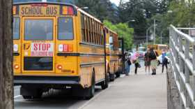 Students exit a school bus outside of Juneau-Douglas High School: Yada.aat Kalé on Aug. 15, 2025