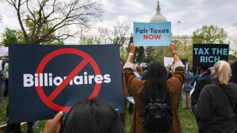 People attend a press conference and rally in support of fair taxation near the U.S. Capitol in Washington, D.C. on April 10, 2025. Tax justice advocates attended the 'Federal Fight Back Rally' to speak out against President Trump's tax cuts for the wealthy, and to urge members of Congress to intervene. (Bryan Dozier/Middle East Images/AFP via Getty Images)