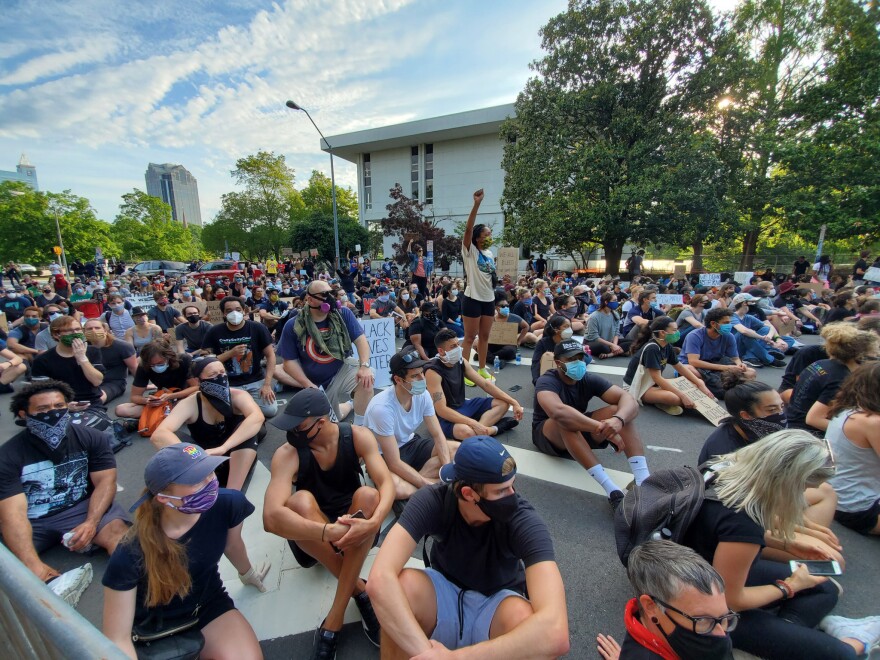 Hundreds of protester sat in silence front of the governor's mansion in downtown Raleigh on Tuesday, June 2, 2020 before chanting and demanding justice for George Floyd, who was killed in Minneapolis while in police custody last week.