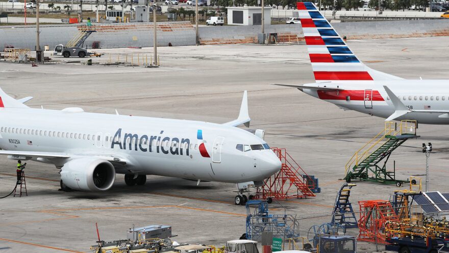 Two grounded American Airlines Boeing 737 Max 8s are seen parked in Miami in 2019. The airline industry is seeing more travelers than in March and April but faces a long road to recovery.