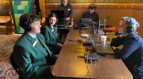 Two state house pages being interviewed by Mikaela Lefrak in the Cedar Creek Room at the Capitol. 