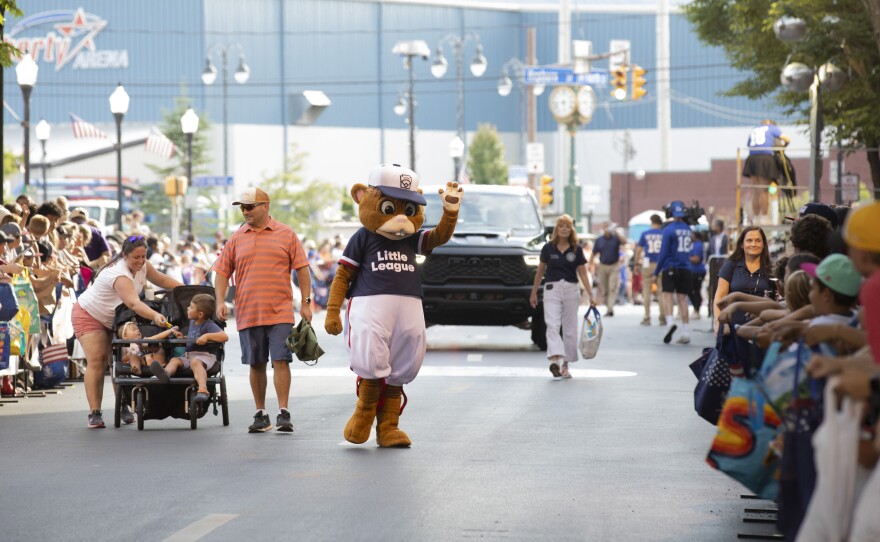 Dugout, the mascot of the Little League World Series, waves to fans during the parade in Williamsport.