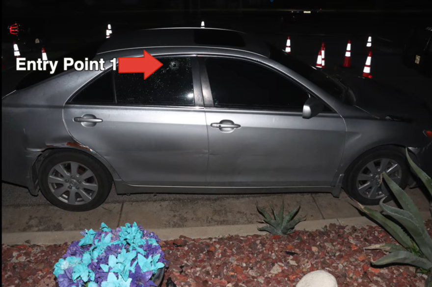 A crime scene photo shows a bullet hole in a vehicle's window following a deadly officer-involved shooting. Police say 25-year-old Emmitt Elijah Mayo was behind this vehicle when officers arrived at the scene, and investigators are determining if the bullet came from Mayo's weapon or another shooter.