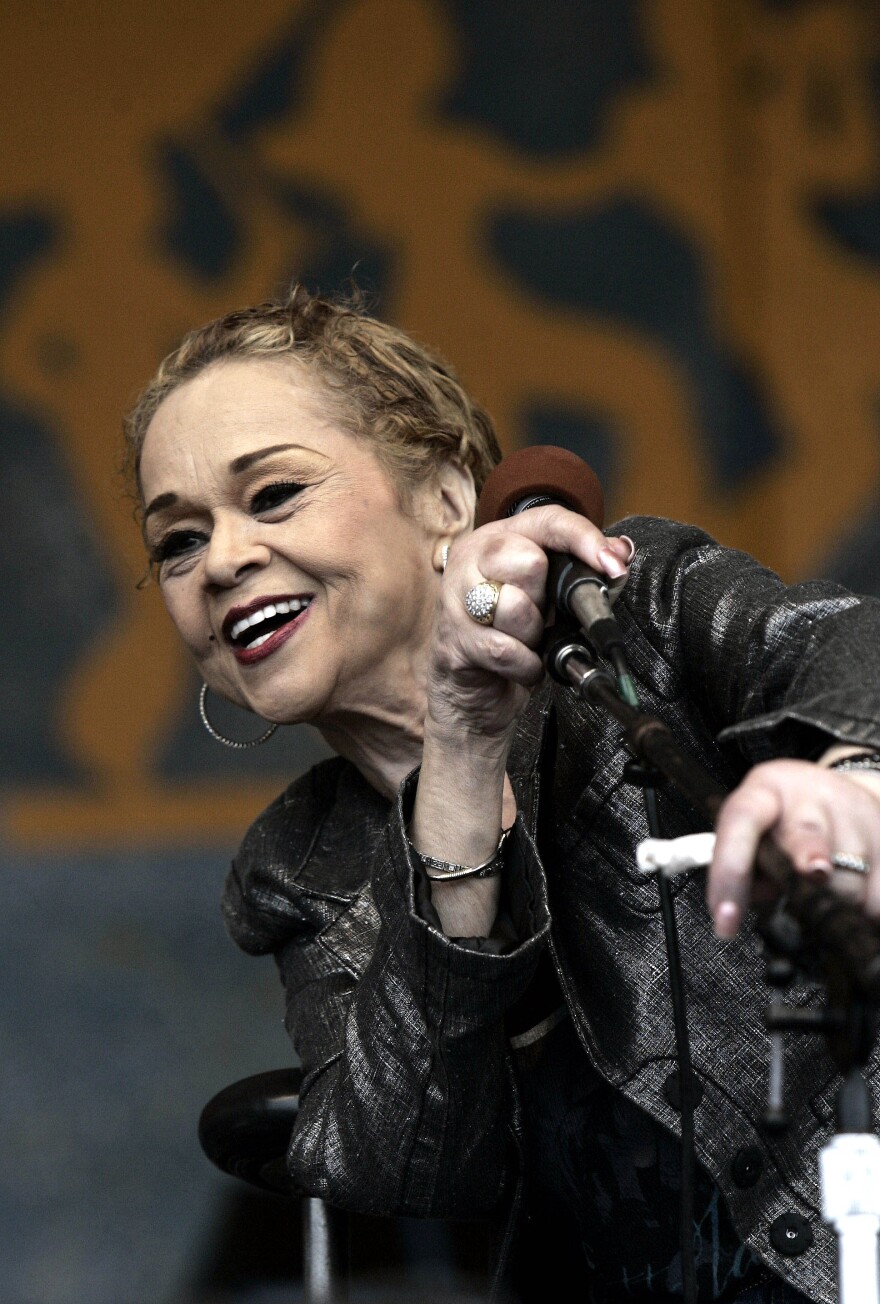 In this April 29, 2006 photo, Etta James performs during the 2006 New Orleans Jazz and Heritage Festival in New Orleans. James, the feisty rhythm and blues singer whose raw, passionate vocals anchored many hits and made the yearning ballad "At Last" an enduring anthem for weddings, commercials and even President Barack Obama.
