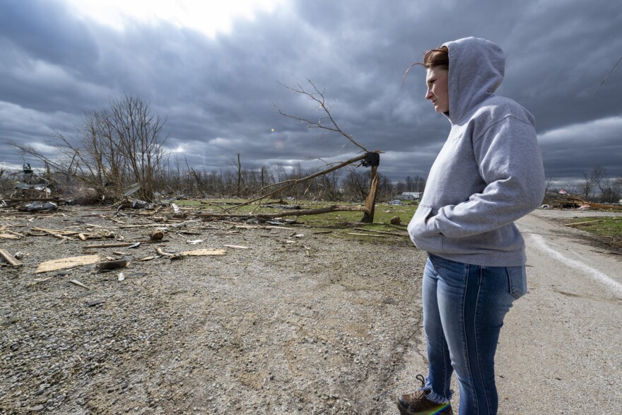 Jaycee Ahlefeld surveys the damage left after a late-night tornado devastated the area in Sullivan, Ind., Saturday, April 1, 2023. Ahlefeld's son attended a day care that had been on what is now an empty lot. Multiple deaths were reported in the area following the storm.