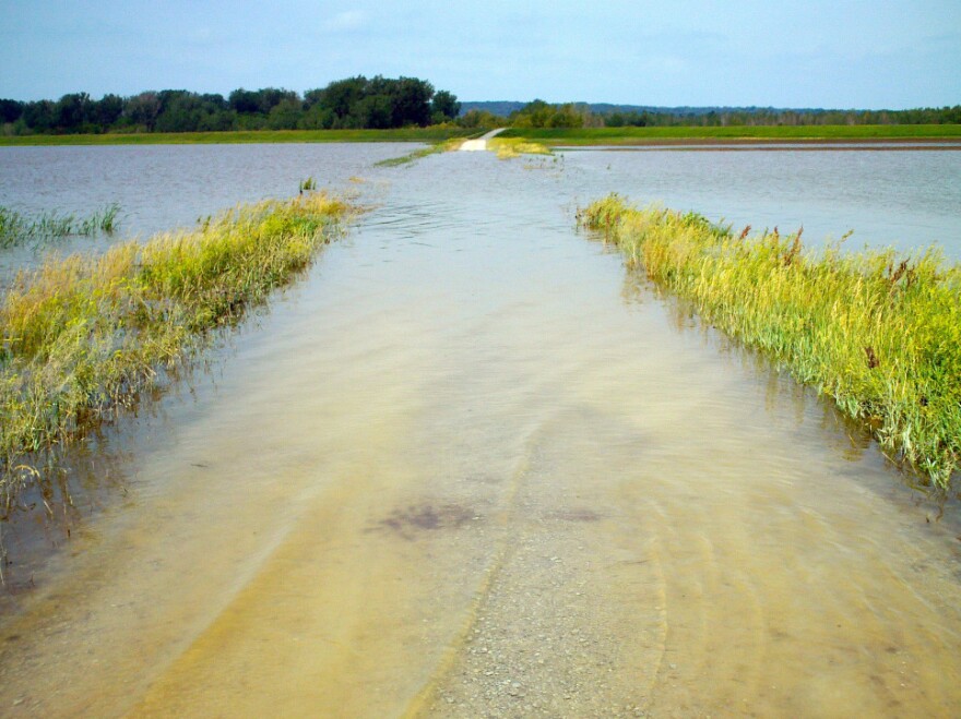 Roads around rural Hamburg, Iowa, were flooded Tuesday after the Missouri River ruptured two levees in northwest Missouri Monday. On Wednesday, water spilling through a nearly 300-foot hole in a levee near Hamburg threatened a secondary levee built to protect the town.