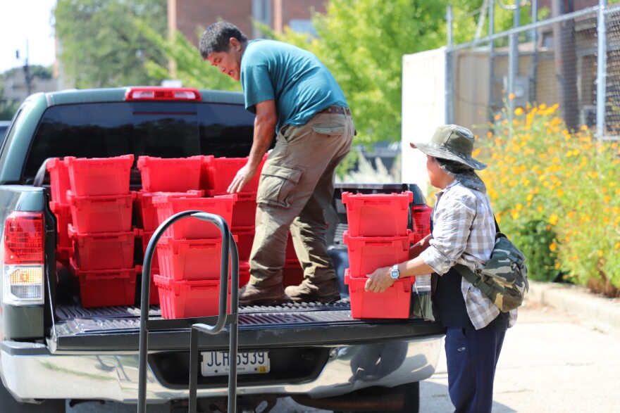 Farmer Heh Si from Burma helps load the produce onto a truck. Ohio City Farm is operated by nonprofit Re:Source Cleveland, which employs refugees to work in the fields as they get acquainted in their new home.
