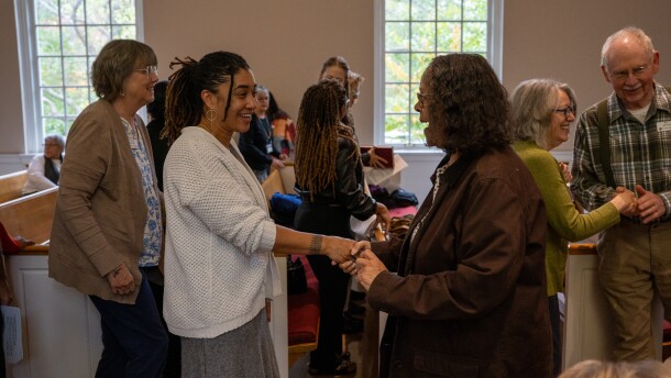 Natasha Lovelace shakes hands with a member of Forest Hill Church. 