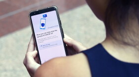 A Government Technology Agency staff member demonstrates Singapore's new contact-tracing smartphone app called TraceTogether, as a preventive measure against COVID-19 coronavirus in Singapore. (Catherine Lai/AFP/Getty Images)