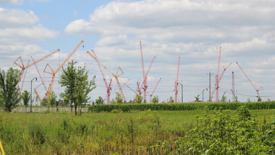 Around a dozen large cranes stand at the read at the Intel Ohio One site 