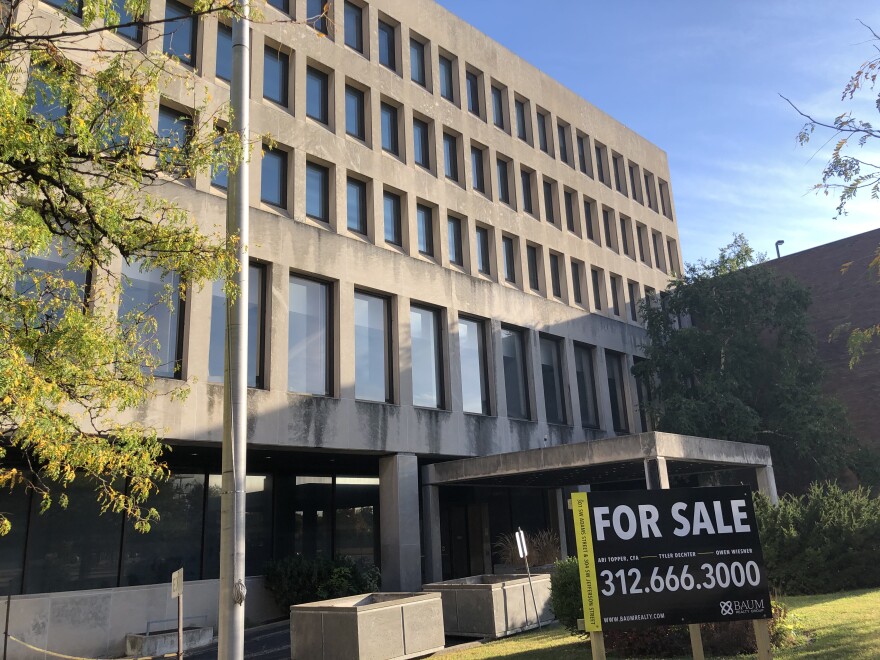 A "for sale sign appears in front of the Creve Coeur Building in downtown Peoria.