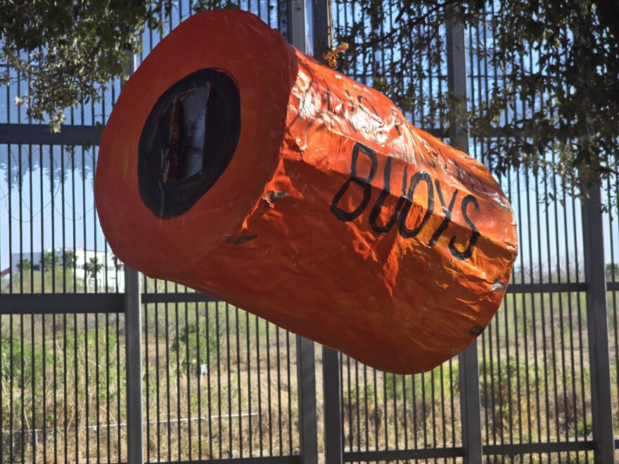A border buoy pinata at a protest against the buoys in Brownsville