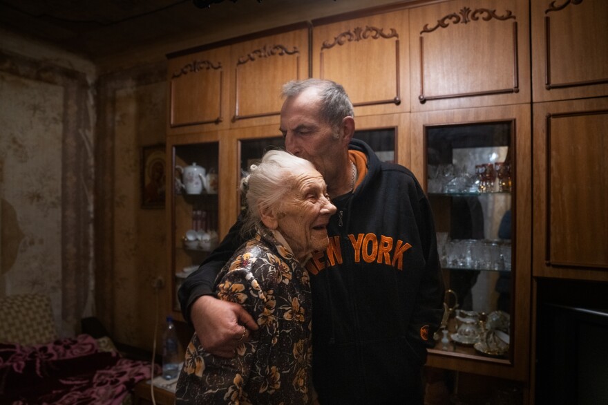 Nadiia Yerkhimovych and her son, Mykhailo, embrace each other in their apartment in Kyiv.