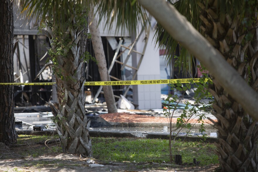 burned out building with police tape.