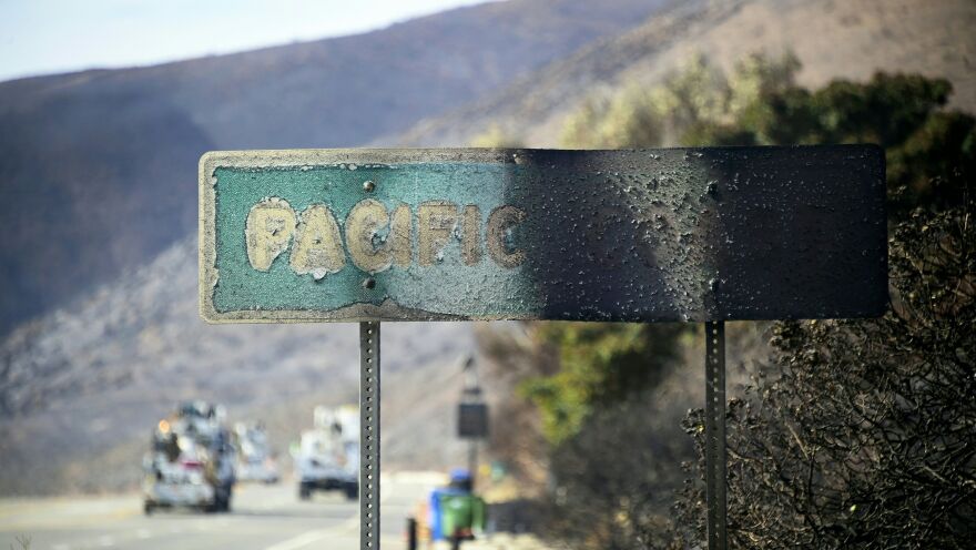 A Pacific Coast Highway sign stands scorched by the side of the road in Malibu, Calif. The Woolsey Fire ravaged some of the area's most iconic landmarks, including a Paramount Ranch left in ruins.