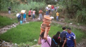 People walk from Venezuela to Colombia through an unauthorized border crossing in Villa del Rosario, Colombia. Some 3.4 million Venezuelans are seeking refuge abroad, with more than 1 million of them in neighboring Colombia, according to the United Nations refugee agency, UNHCR. Many people are leaving Venezuela by foot.