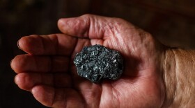Stock photo of someone holding coal