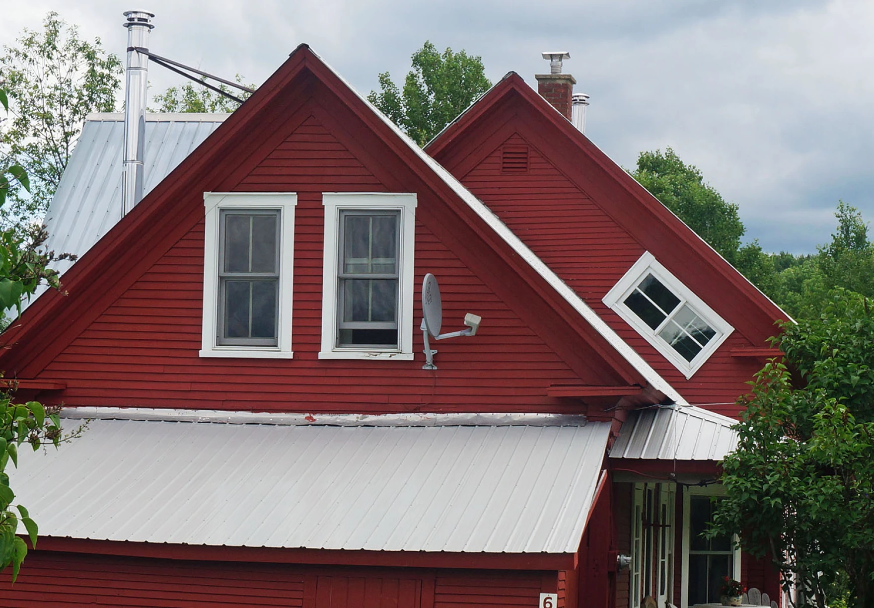 A home in Vermont with a witch window on the upper floor